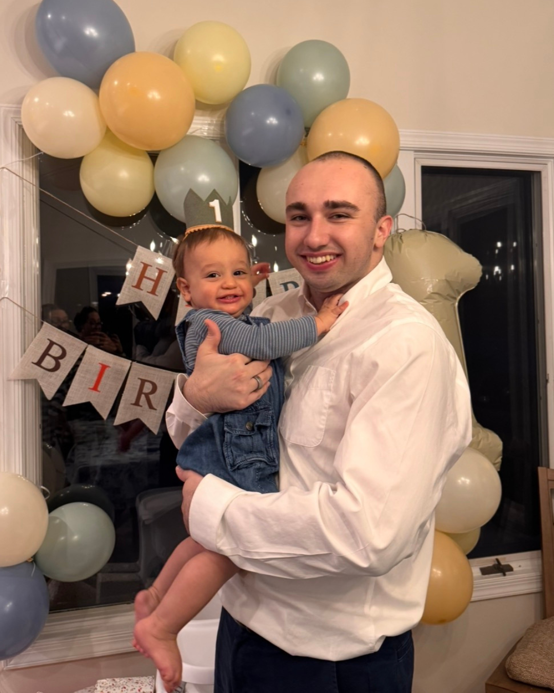 James holding Jesse at his first birthday celebration